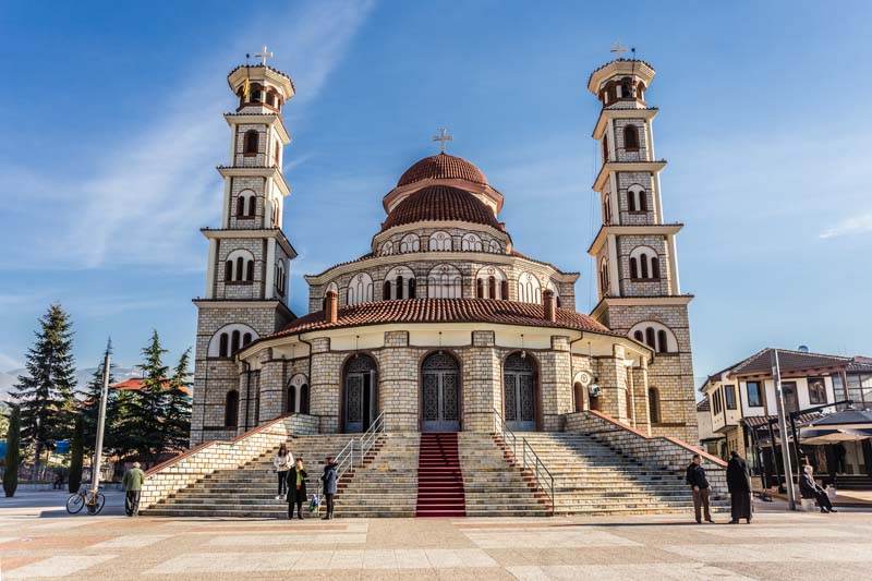 Neo-Byzantine Orthodox Cathedral, white stone and red tile roofs in Korçë, Albania