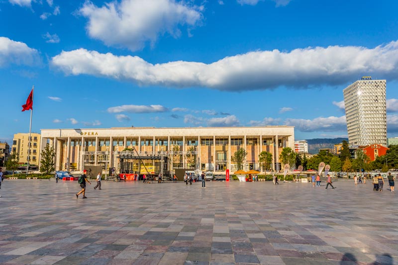 Tirana, Albania: Skënderbeu square, Palace of Culture, Opera House. Beautiful clouds and summer sunset light, golden hour