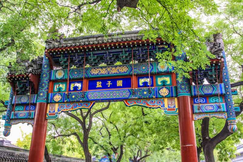 Pailou, traditional wooden entrance archway to old street in Beijing, China