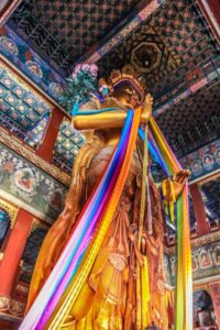 Sandalwood statue of Maitreya Buddha inside Yonghegong Lama Temple in Beijing, China. Buddhist Chinese art