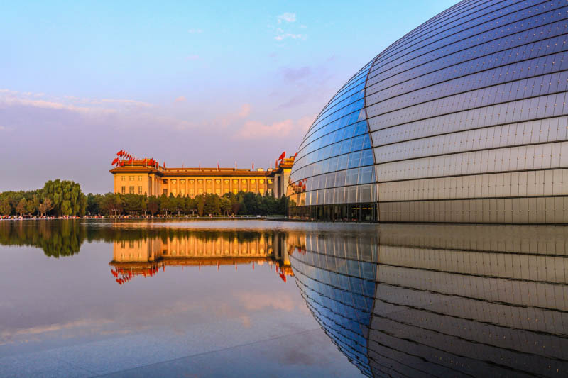 Beijing, China, National Centre for the Performing Arts and Great Hall of the People. Golden hour photography, modern architecture and stalinist architecture, water reflection