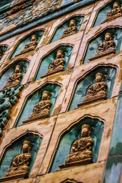 Summer Palace, Beijing, China. Detail of the Hall of the Sea of Wisdom in Longevity Hill. Glazed yellow Boddhistvas in green niches