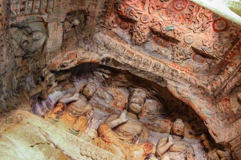 Yungang Grottoes, Datong, China: Entrance to Cave no. 9. Intricate carvings with colours