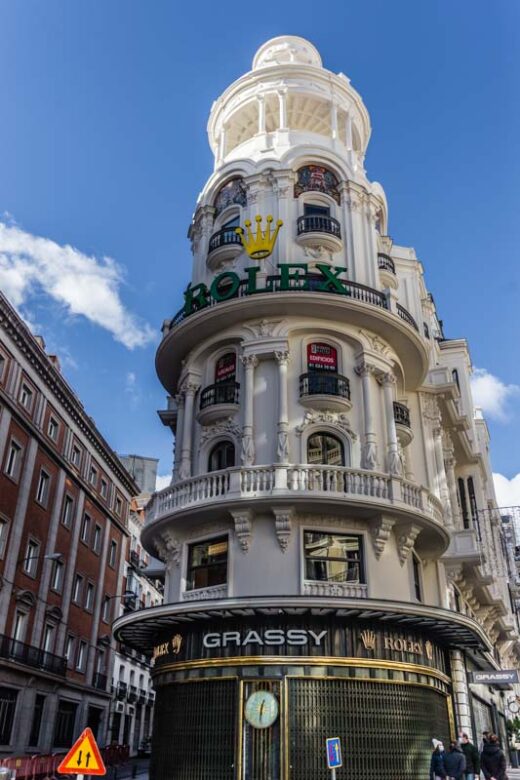 Neoclassical building in white stone built in 1910 in central avenue Gran Vía, Madrid