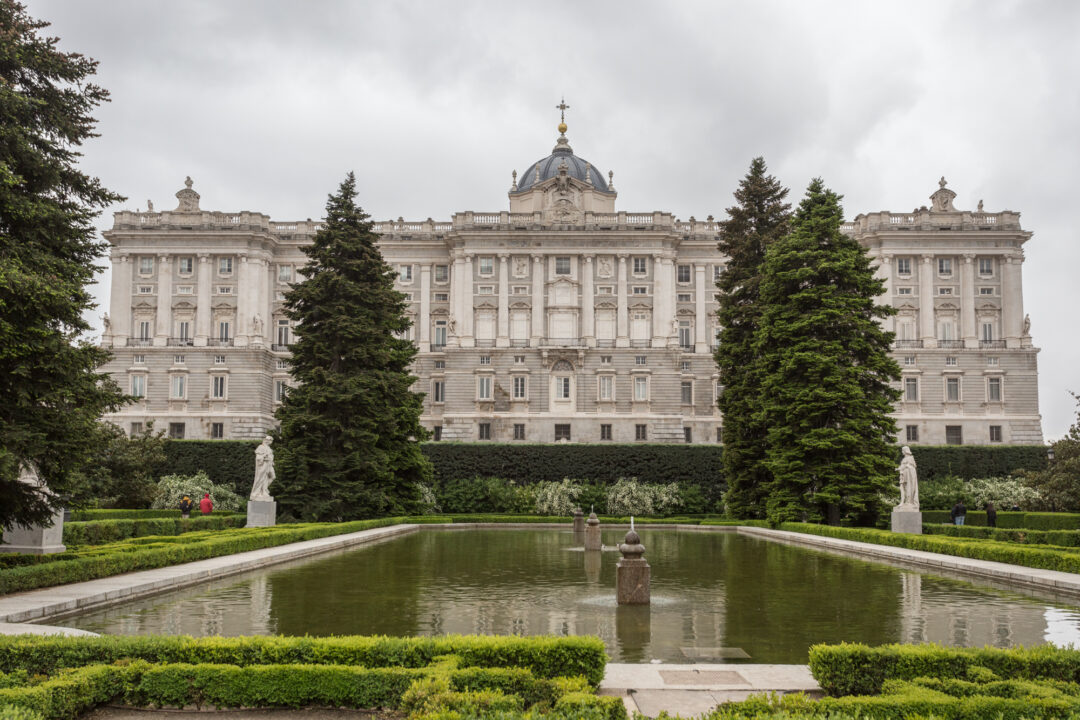 Gardens with fountain and statues of Madrid Royal Palace, 18th century Baroque building made of granite