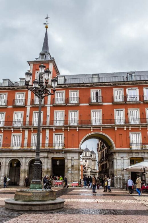 Entrance archway of historical main market square in Madrid old city, plaza mayor