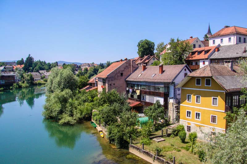 Houses by a river and trees in Novo mesto, Slovenia